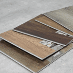 Technician preparing tile samples for slip resistance testing in lab.