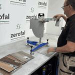 A clean, organised layout of multiple tile samples in different colours and finishes beside a Wessex pendulum tester