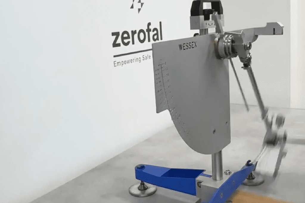 Tile sample undergoing wet pendulum slip resistance testing in laboratory using Wessex Portable Skid Resistance Tester with red base